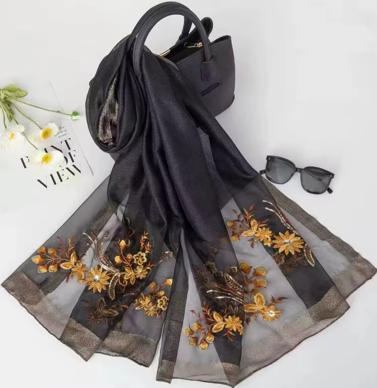 Women's black embroidered floral silk scarf with gold flower detailing and elegant georgette shawl design